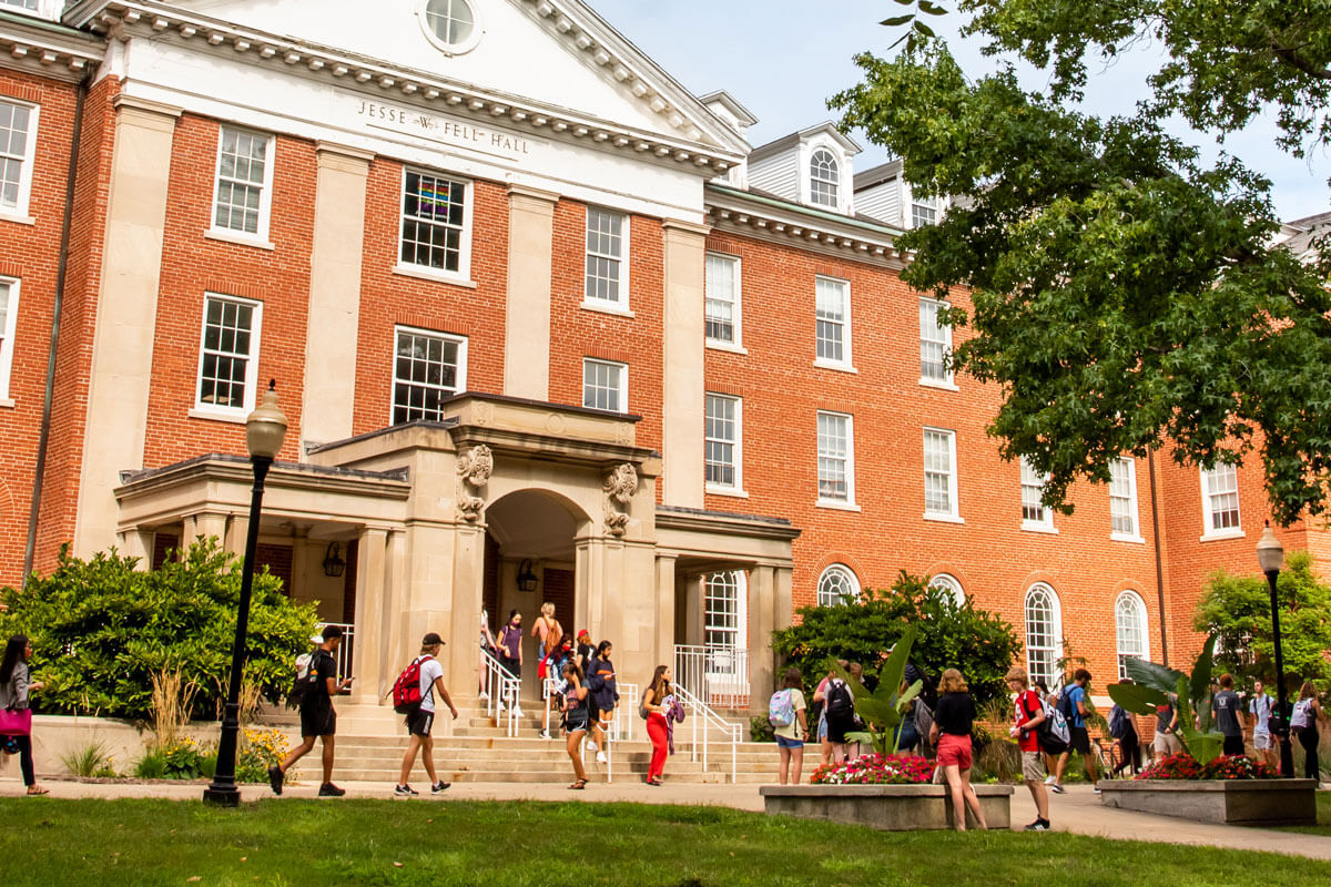 Students walk in front of Fell Hall.